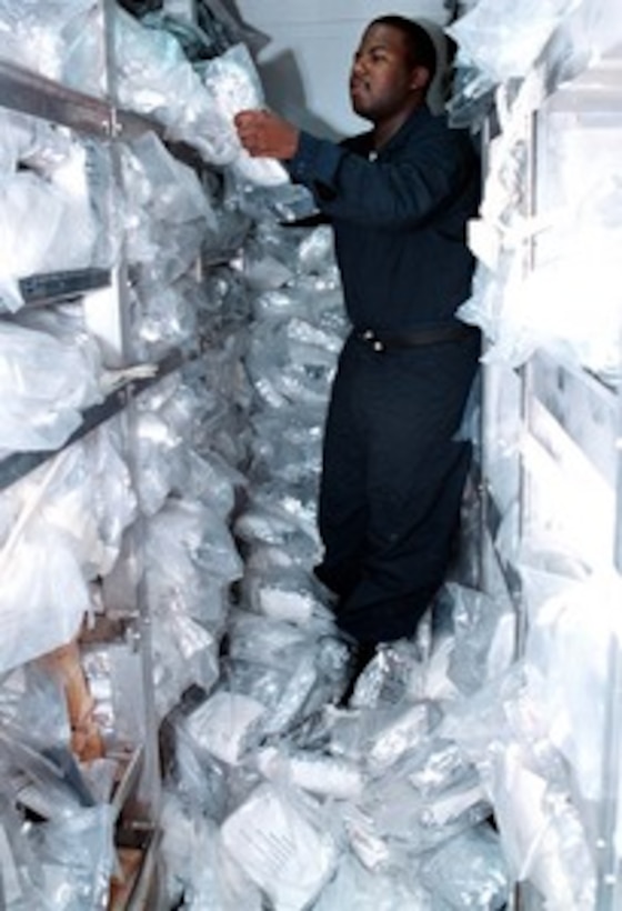 Fireman Russell Legett inspects and inventories chemical protective garments before being issued to the crew members of the USS George Washington (CVN 73) as the ship heads towards the Persian Gulf on Nov. 19, 1997. All crew members will have received equipment issue and training for chemical and biological warfare prior to entering the Persian Gulf. The aircraft carrier and its battle group have been ordered to the to join the aircraft carrier USS Nimitz (CVN 68) battle group already on station. The two battle groups will be operating in the Persian Gulf in support of Operation Southern Watch which is the U.S. and coalition enforcement of the no-fly-zone over Southern Iraq. Legett is from Florence, S.C. 