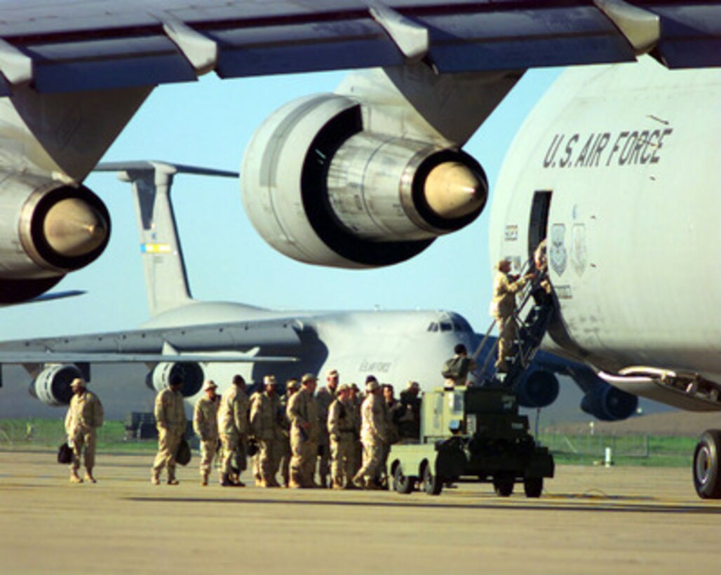 U.S. Air Force personnel board a C-5 Galaxy for the Persian Gulf area of operations at Moron Air Base, Spain, on Nov. 22, 1997. The airmen will support over 170 U.S. Air Force aircraft operating in the region as part of Operation Southern Watch which is the U.S. and coalition enforcement of the no-fly-zone over Southern Iraq. 