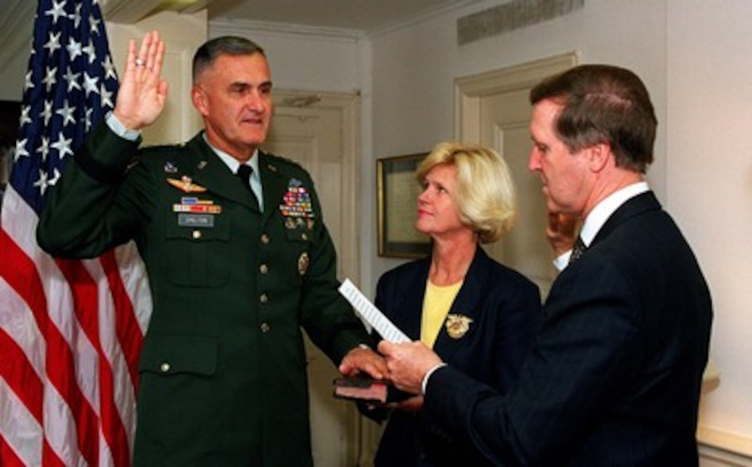 Gen. Henry H. Shelton (left), U.S. Army, is sworn in as the 14th chairman of the Joint Chiefs of Staff by Secretary of Defense William S. Cohen (right) as Shelton's wife Carolyn (center) holds the Bible in a private ceremony in the Pentagon on Sept. 30, 1997. Shelton replaces the retiring Gen. John M. Shalikashvili as the nation's top military officer. 