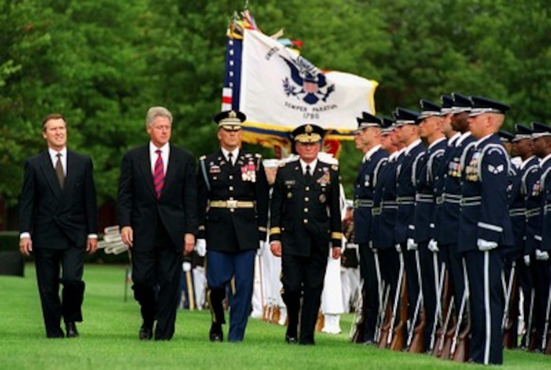 Secretary of Defense William S. Cohen (left), President Bill Clinton (center left), Col. Greg Gardner (center right), U.S. Army, accompany Chairman of the Joint Chiefs of Staff Gen. John M. Shalikashvili (right), U.S. Army, as he inspects the joint services honor guard during his farewell ceremony at Fort Myer, Va., on Sept. 30, 1997. Shalikashvili is retiring from the U.S. Army and his job as the nation's senior military officer and will be succeeded by Gen. Henry H. Shelton, U.S. Army. Gardner is the Commander, 3rd U.S. Infantry (The Old Guard). 