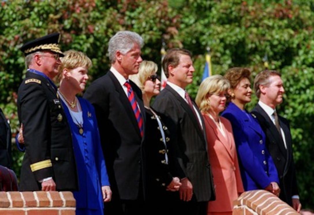 (Left to right) Chairman of the Joint Chiefs of Staff Gen. John M. Shalikashvili, Joan Shalikashvili, President Bill Clinton, Hillary Rodham Clinton, Vice President Al Gore, Tipper Gore, Janet Cohen and Secretary of Defense William S. Cohen watch as troops from the joint services honor guard pass in review during the farewell ceremony for the Army general at Fort Myer, Va., on Sept. 30, 1997. Shalikashvili is retiring from the U.S. Army and his job as the nation's senior military officer and will be succeeded by Gen. Henry H. Shelton, U.S. Army. President Bill Clinton awarded Shalikashvili the Presidential Medal of Freedom earlier in the ceremony. 