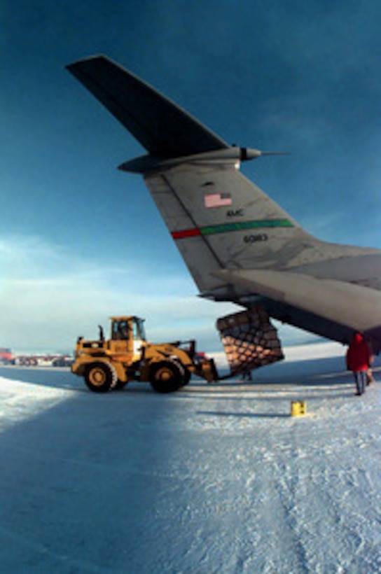 Cargo is off-loaded from a U.S. Air Force C-141B Starlifter parked on a runway of ice at McMurdo Base, Antarctica, on Sept. 30, 1997. The aircraft is bringing in supplies and equipment in support of Operation Deep Freeze. Deep Freeze is joint military operation of the U.S. armed forces and the New Zealand Defence Forces, to provide logistic support for the U.S. National Science Foundation's Antarctic program. The Starlifter is deployed to Christchurch, New Zealand, from the 62nd Airlift Wing, McChord Air Force Base, Wash. 