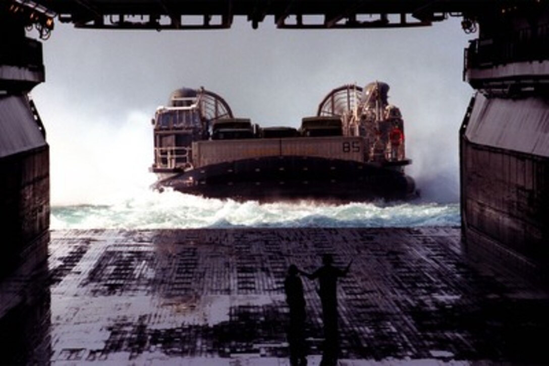 A U.S. Navy Landing Craft Air Cushion, loaded with equipment from the 26th Marine Expeditionary Unit, prepares to enter the well deck of the USS Wasp (LHD 1) as the ship steams off the coast of Camp Lejeune, N.C., on Oct. 8, 1997. The Landing Craft Air Cushion, or LCAC as it is more commonly called, is a hydrofoil craft used to ferry troops and equipment for amphibious landing operations. This Navy-Marine Corps team is honing their skills in preparation for their up-coming deployment. 