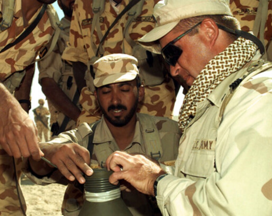 A Kuwaiti and a U.S. soldier work together to prepare an explosive during Exercise Bright Star 98 at the Mubarek Military City compound outside Cairo, Egypt, on Oct. 19, 1997. Bright Star 98 is a joint/combined coalition tactical air, ground, naval and special operations forces field training exercise in Egypt. Members of the U.S. Central Command's Army, Air Force, Navy, Marine and special operations components, and members of the Air and Army National Guard, and forces from Egypt, the United Arab Emirates, Kuwait, France, Italy and the United Kingdom are taking part in the exercise. The exercise is intended to improve readiness and interoperability between U.S., Egyptian and coalition forces. 