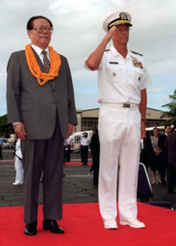 Chinese President Jiang Zemin (left) and Commander in Chief, U.S. Pacific Command Adm. Joseph W. Prueher (right), U.S. Navy, stand as honors for Jiang are rendered during arrival ceremonies at Hickam Air Force Base, Hawaii, Oct. 26, 1997. 