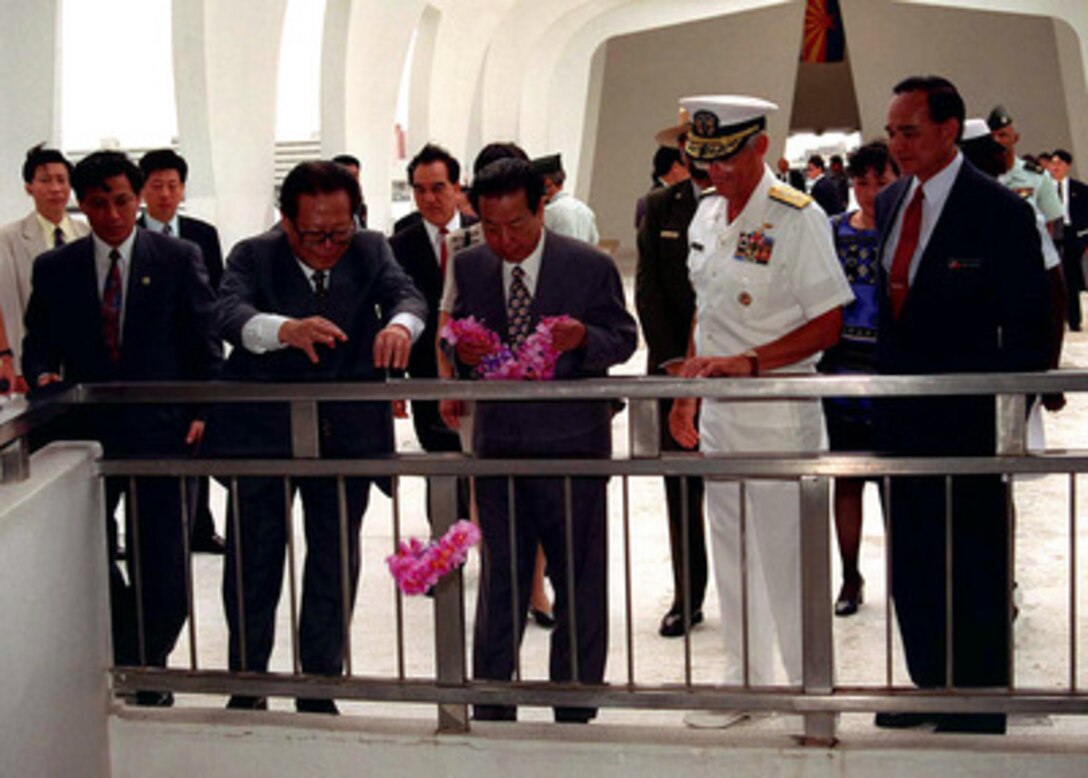 Chinese President Jiang Zemin (left) drops a lei into the viewing well at the USS Arizona Memorial during his visit to Pearl Harbor, Hawaii, on Oct. 26, 1997. The Jiang visit was hosted by Commander in Chief, U.S. Pacific Command Adm. Joseph W. Prueher (right), U.S. Navy. 