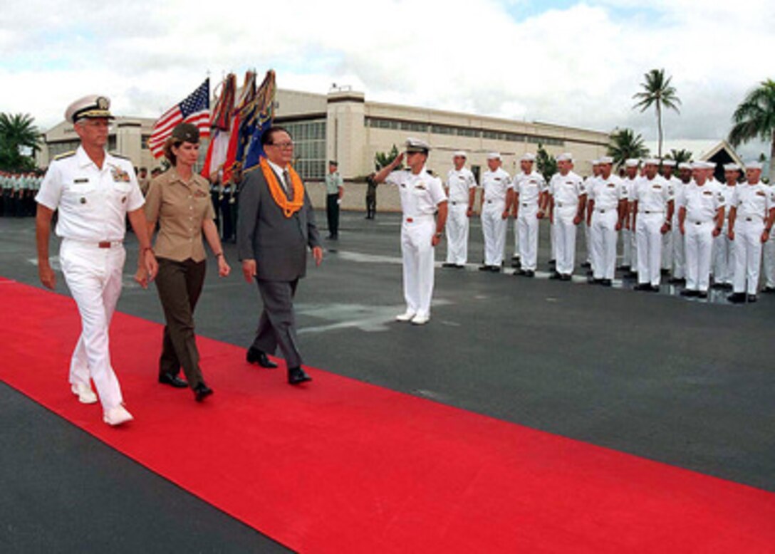 Commander in Chief, U.S. Pacific Command Adm. Joseph W. Prueher (left), U.S. Navy, and Commander of Troops Col. Sheryl Murray (center), U.S. Marine Corps, escort Chinese President Jiang Zemin (right) for a review of the joint honor guard during arrival ceremonies at Hickam Air Force Base, Hawaii, on Oct. 26, 1997. 