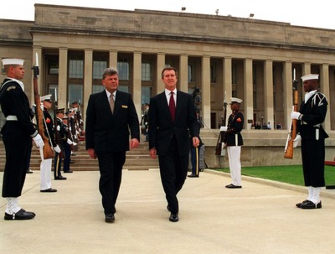 Secretary of Defense William S. Cohen (right) escorts Minister of National Defense Ceslovas Stankevicius (left), of the Republic of Lithuania, to an armed forces full honors ceremony welcoming Stankevicius to the Pentagon on Oct. 16, 1997. 