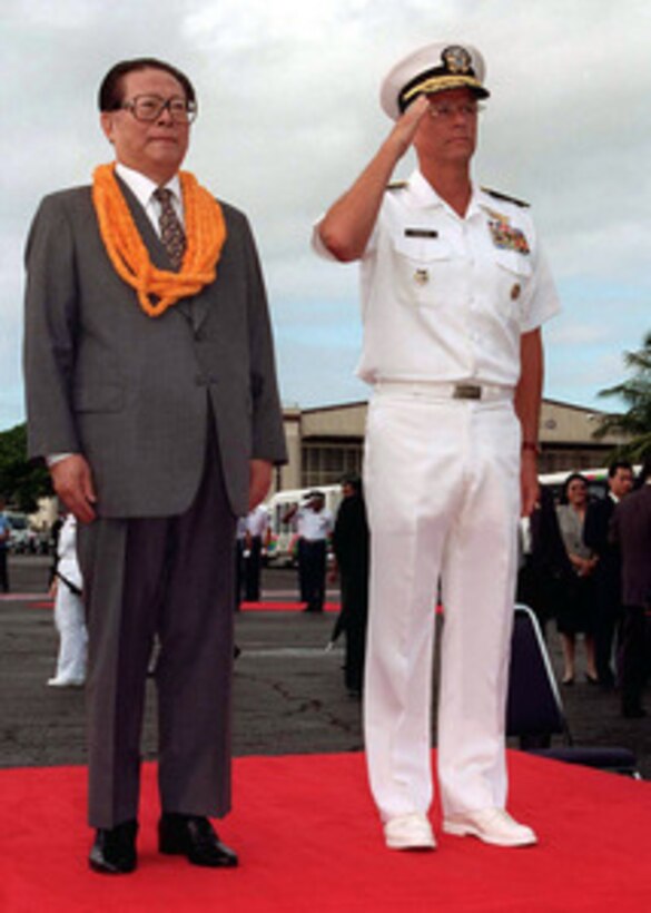 Chinese President Jiang Zemin (left) and Commander in Chief, U.S. Pacific Command Adm. Joseph W. Prueher (right), U.S. Navy, stand as honors for Jiang are rendered during arrival ceremonies at Hickam Air Force Base, Hawaii, Oct. 26, 1997. 