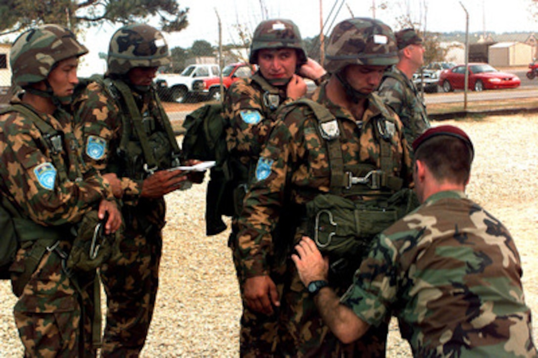 Uzbekistan soldiers have their parachute harnesses checked before a practice jump from a tower at Fort Bragg, N. C., on Sept. 8, 1997. The soldiers will take part in the longest distance airborne operation in history during Exercise Central Asian Battalion '97. Exercise Central Asian Battalion '97 involves more than 900 military personnel from Georgia, Kazakhstan, Kyrgyzstan, Latvia, Russia, Ukraine and Uzbekistan who are training with over 500 U.S. military troops to hone their skills in peacekeeping and humanitarian assistance. The exercise will enhance regional cooperation and increase interoperability training among NATO and Partnership for Peace nations. The exercise is being held in Shymkent, Kazakhstan, and Chirchik, Uzbekistan. 