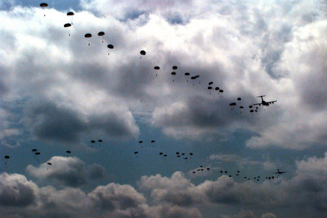 Soldiers of the U.S. Army's 82nd Airborne Division stream out from two U.S. Air Force C-17 Globemasters III over the Sicily dropzone at Fort Bragg, N.C., on Sept. 11, 1997. The soldiers are rehearsing to take part in the longest distance airborne operation in history during Exercise Central Asian Battalion '97. Exercise Central Asian Battalion '97 involves more than 900 military personnel from Georgia, Kazakhstan, Kyrgyzstan, Latvia, Russia, Ukraine and Uzbekistan who are training with over 500 U.S. military troops to hone their skills in peacekeeping and humanitarian assistance. The exercise will enhance regional cooperation and increase interoperability training among NATO and Partnership for Peace nations. The exercise is being held in Shymkent, Kazakhstan, and Chirchik, Uzbekistan. 
