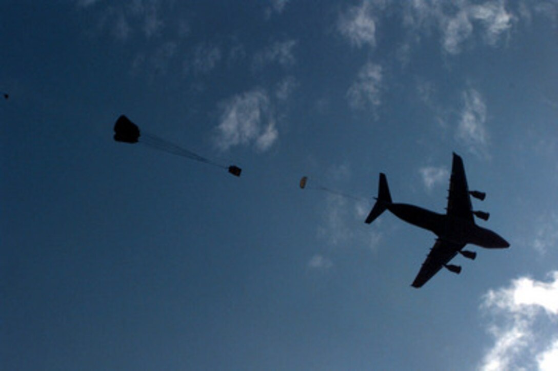 Heavy equipment from the U.S. Army's 82nd Airborne Division is dropped from a U.S. Air Force C-17 Globemaster III over the Sicily dropzone at Fort Bragg, N.C., on Sept. 11, 1997. The soldiers and airmen are rehearsing to take part in the longest distance airborne operation in history during Exercise Central Asian Battalion '97. Exercise Central Asian Battalion '97 involves more than 900 military personnel from Georgia, Kazakhstan, Kyrgyzstan, Latvia, Russia, Ukraine and Uzbekistan who are training with over 500 U.S. military troops to hone their skills in peacekeeping and humanitarian assistance. The exercise will enhance regional cooperation and increase interoperability training among NATO and Partnership for Peace nations. The exercise is being held in Shymkent, Kazakhstan, and Chirchik, Uzbekistan. 