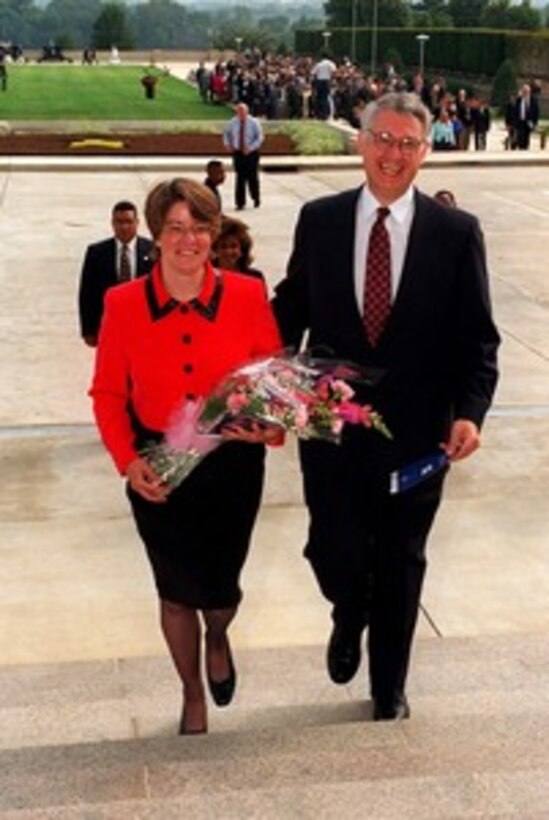 Deputy Secretary of Defense John J. Hamre and his wife Julie enter the Pentagon following a Full Honors Review and Welcoming Ceremony on Sept. 8, 1997, hosted by Secretary of Defense William S. Cohen. Hamre was sworn in as the 26th Deputy Secretary of Defense on July 29, 1997. 
