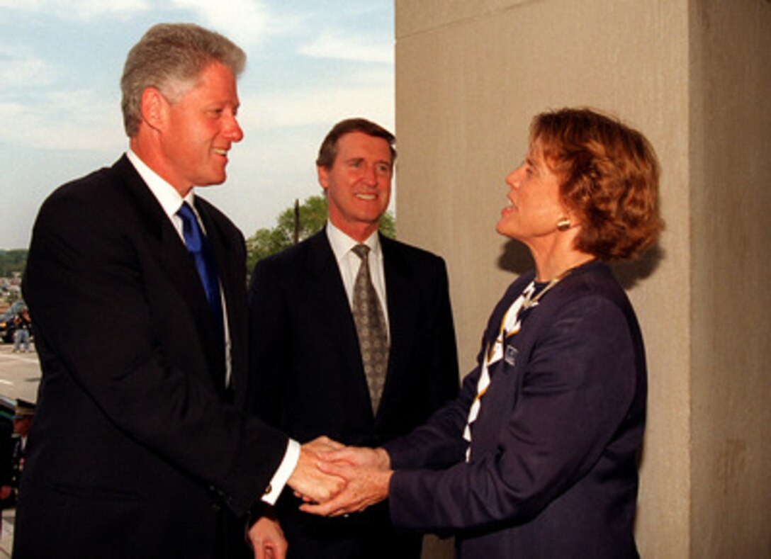 President Bill Clinton (left) is greeted by Secretary of the Air Force Sheila Widnall (right), and Secretary of Defense William S. Cohen (center) as he arrives at the Pentagon on Sept. 18, 1997. Clinton is taking part in the celebration of the 50th anniversary of the U.S. Air Force. 
