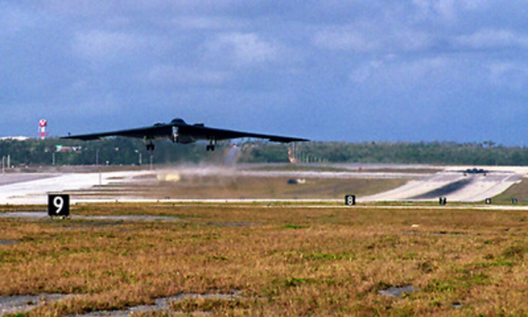 One U.S. Air Force B-2 Spirit bomber takes off as another waits to roll out from Andersen Air Force Base, Guam, on March 27, 1998, for missions over the Northern Mariana Islands during Exercise Island Spirit. The two stealth bombers are forward deployed to Guam for the Air Command exercise. 