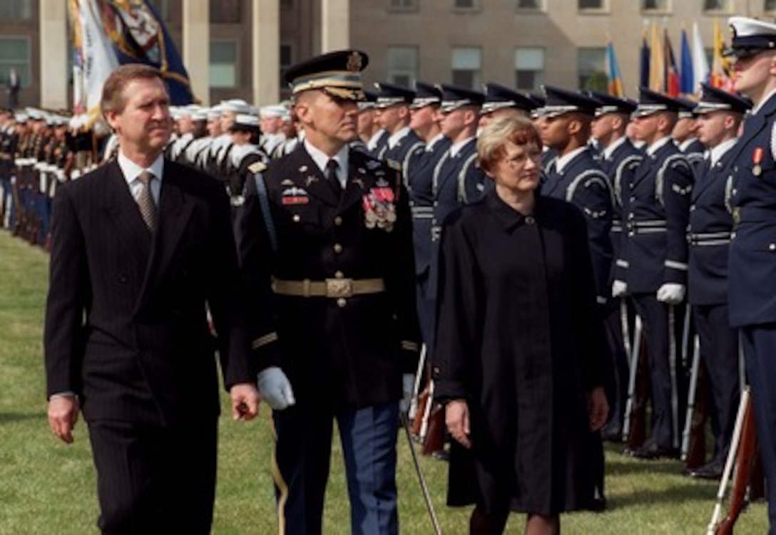 Secretary of Defense William Cohen (left) accompanies his guest, Finland's Defense Minister Anneli Taina (right), as she inspects the joint services honor guard on the Pentagon parade field, March 26, 1998. Accompanying the two senior defense leaders is the Commander of Troops for the ceremony, Col. Gregory Gardner, U.S. Army, of the 3d U.S. Infantry (The Old Guard). Cohen will later meet with Minister Taina and her delegation to discuss a range of security issues of mutual interest to both nations. 