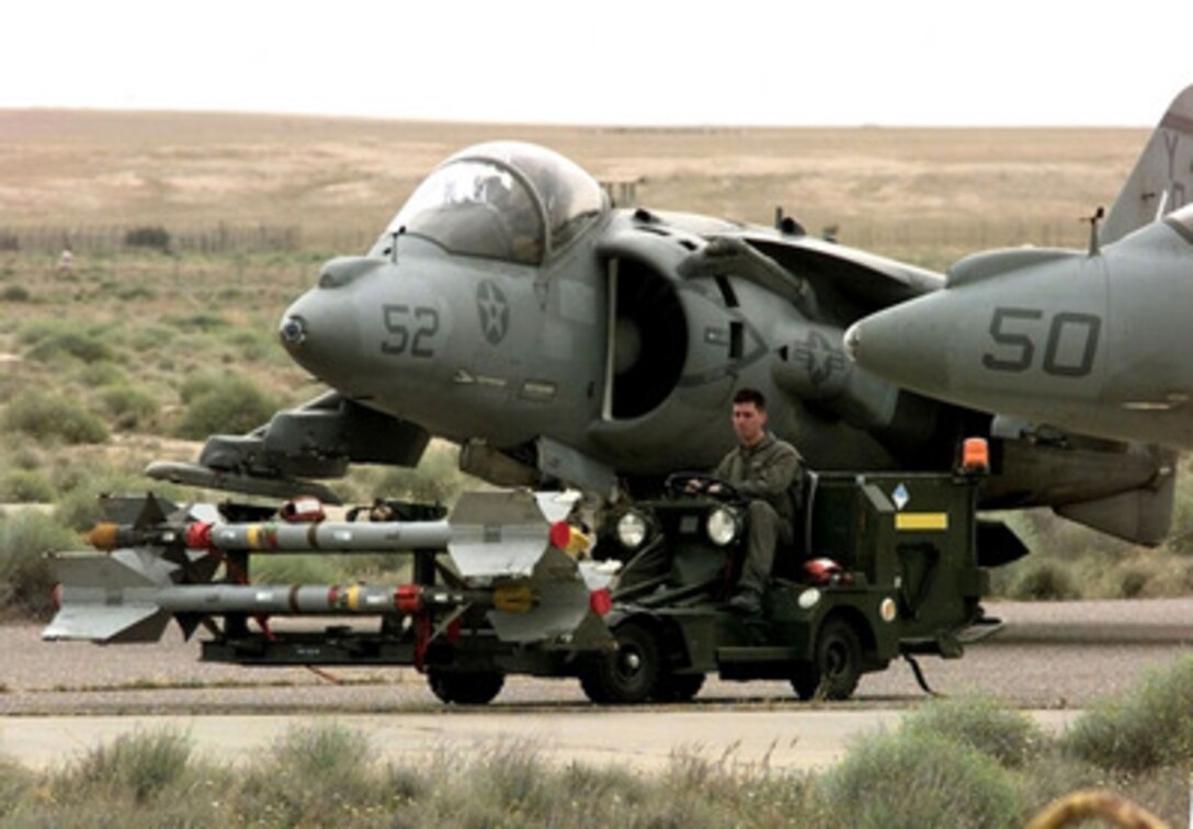 A Marine drives a cart of Sidewinder missiles to load onto AV-8B Harrier jets on the flight line of Ali Al Salem Air Base, Kuwait, on March 29, 1998. The Harriers are assigned to the 11th Marine Expeditionary Unit and are flying in support of Operation Southern Watch, which is the U.S. and coalition enforcement of the no-fly-zone over Southern Iraq. 