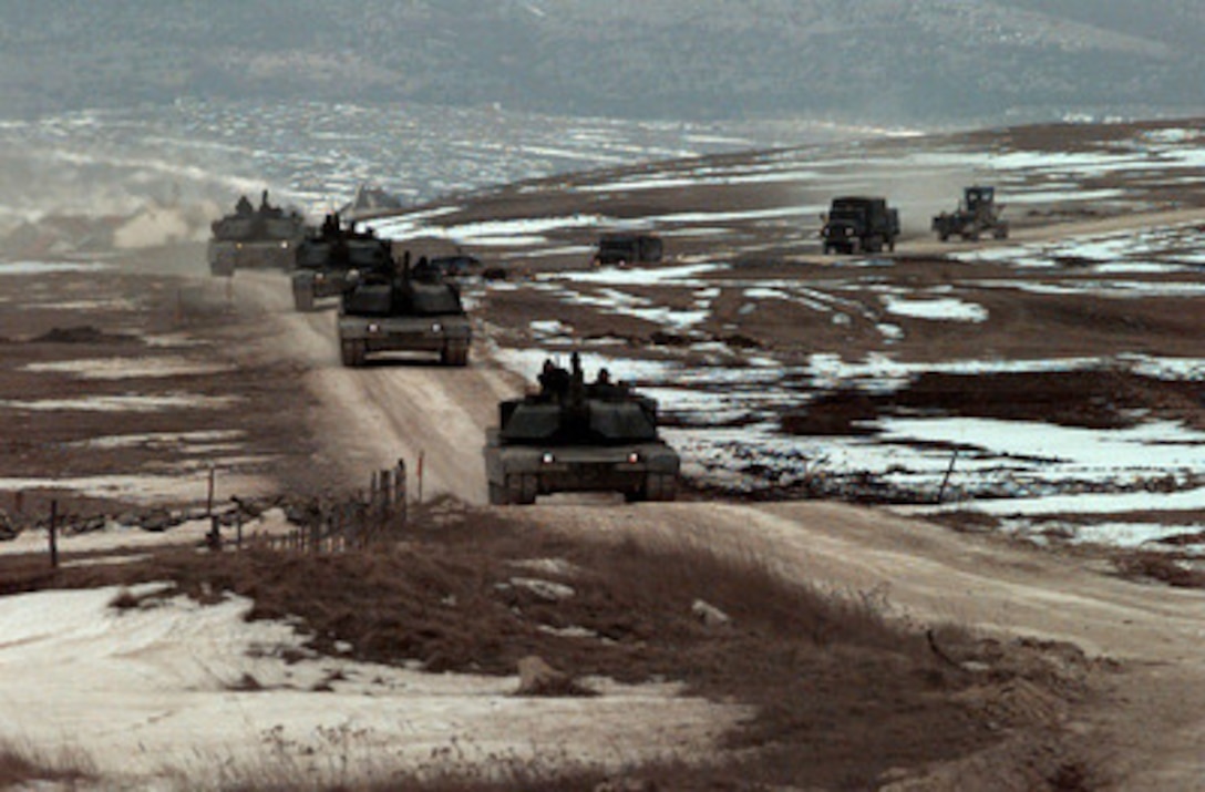 U.S. Army 1st Armored Division M-1A1 Abrams main battle tanks convoy to the Glamoc Ranges in Bosnia and Herzegovina on March 26, 1998. The tankers are going to the ranges to zero in their M1 Abrams at a distance of 1520 meters and to practice platoon or volley fire. The tankers are deployed to Bosnia and Herzegovina as part of the Stabilization Force in Operation Joint Guard. 