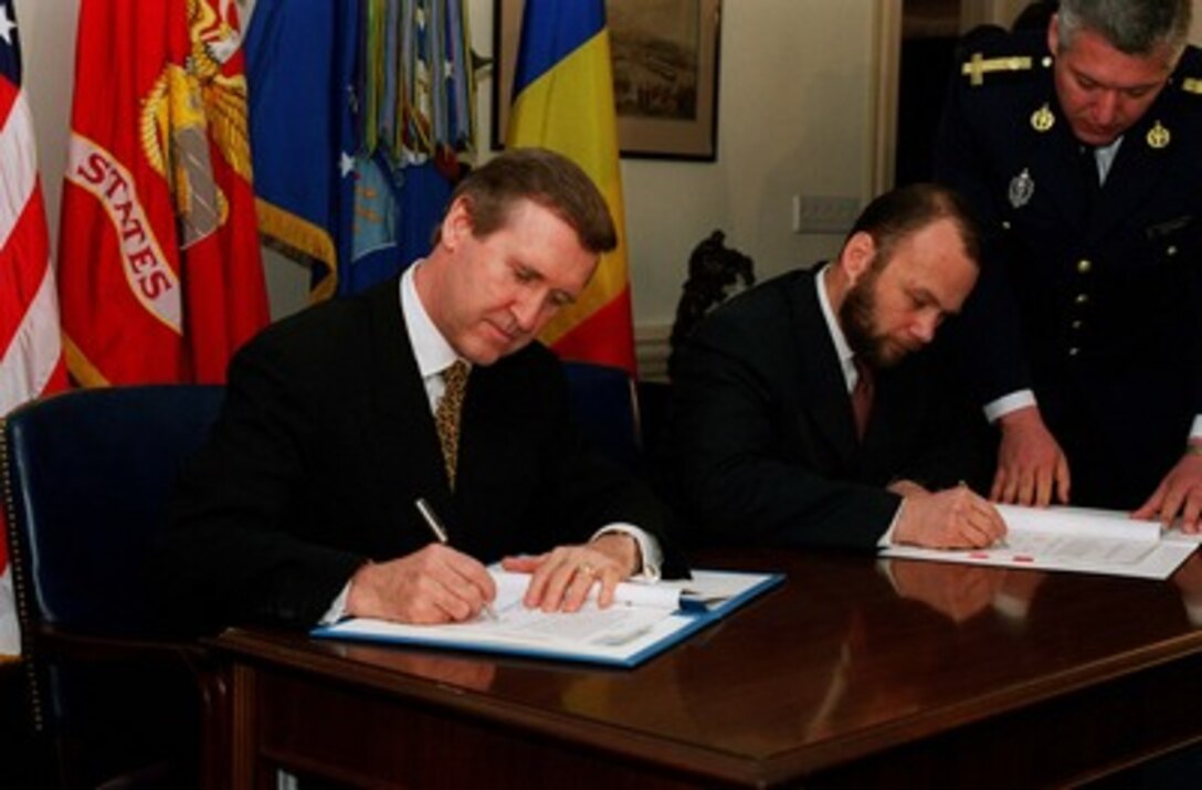 Secretary of Defense William S. Cohen (left) and Minister of Defense Constantin D. Ionescu (right), of Romania, sign an Agreement of Cooperation in the area of Counterproliferation of Weapons of Mass Destruction and Promotion of Defense and Military Relations, in the Pentagon on March 30, 1998. 