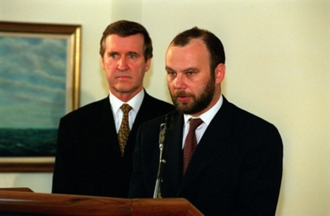 Minister of Defense Constantin D. Ionescu (right), of Romania, responds to a reporter's question as Secretary of Defense William S. Cohen (left) listens during a media availability in the Pentagon on March 30, 1998. The defense leaders held a joint press availability after signing an Agreement of Cooperation in the area of Counterproliferation of Weapons of Mass Destruction and Promotion of Defense and Military Relations. 