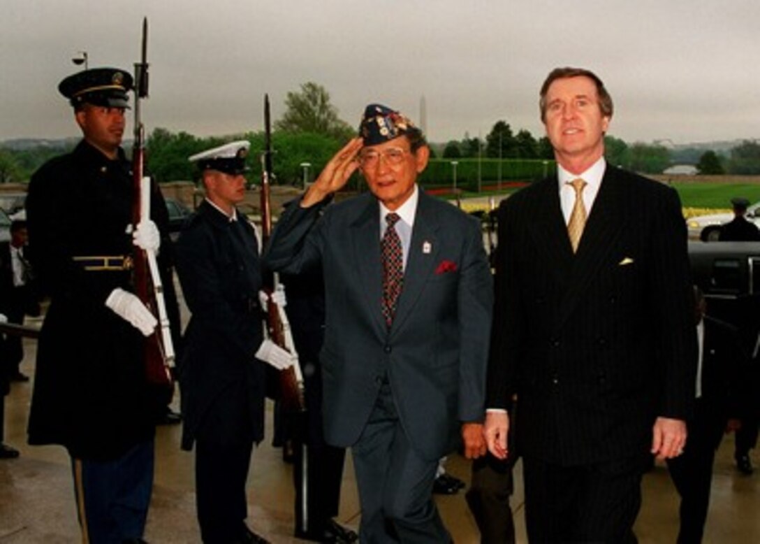 Secretary of Defense William S. Cohen (right) escorts President Fidel V. Ramos (left), of the Republic of the Philippines, through a cordon of honor guards into the Pentagon on April 9, 1998. Ramos will meet with Cohen and other Department of Defense officials including Gen. Henry H. Shelton, U.S. Army, chairman of the Joint Chiefs of Staff, to discuss bilateral relationships, Asia-Pacific security issues and regional developments. 