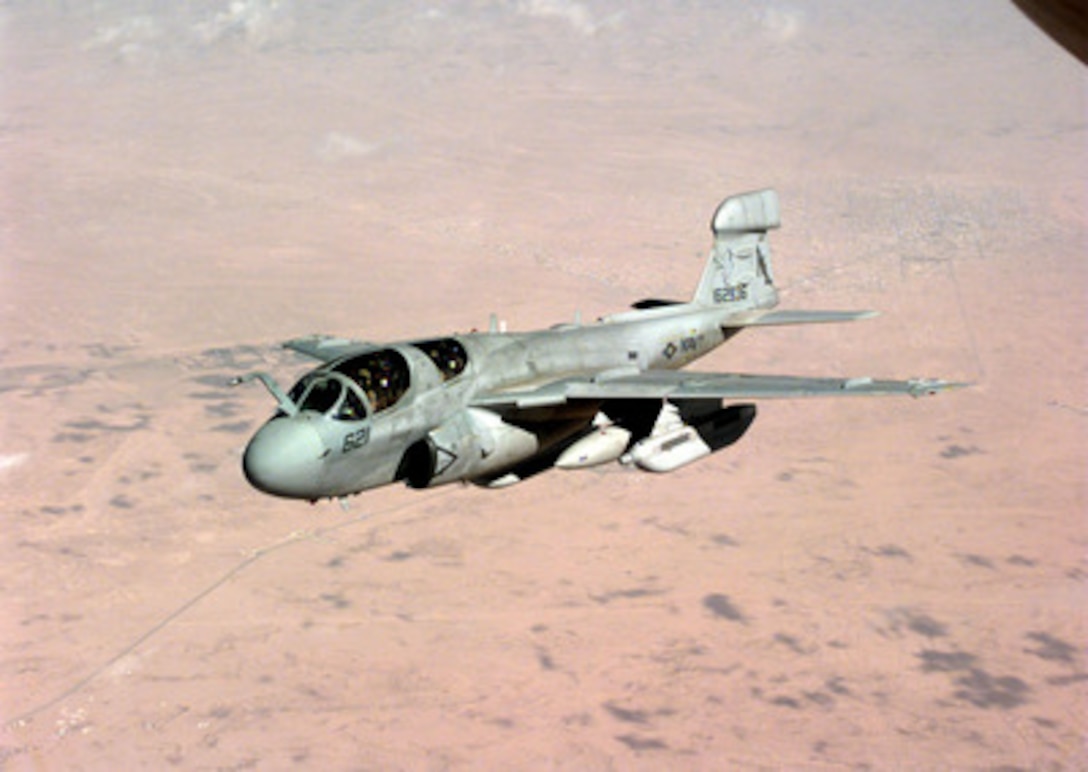 A U.S. Navy EA-6B Prowler drops away from a U.S. Air Force KC-135R Stratotanker after refueling over the desert of Saudi Arabia on April 3, 1998. The Prowler and Stratotanker are flying in support of Operation Southern Watch, which is the U.S. and coalition enforcement of the no-fly-zone over Southern Iraq. The Prowler has taken over the electronic countermeasures mission from the retiring EF-111A Raven of the U.S. Air Force. The Prowler belongs to Tactical Electronic Warfare Squadron 142. The Stratotanker is attached to the 4408th Air Refueling Squadron (Provisional). Both aircraft are flying out of Prince Sultan Air Base, Saudi Arabia. 
