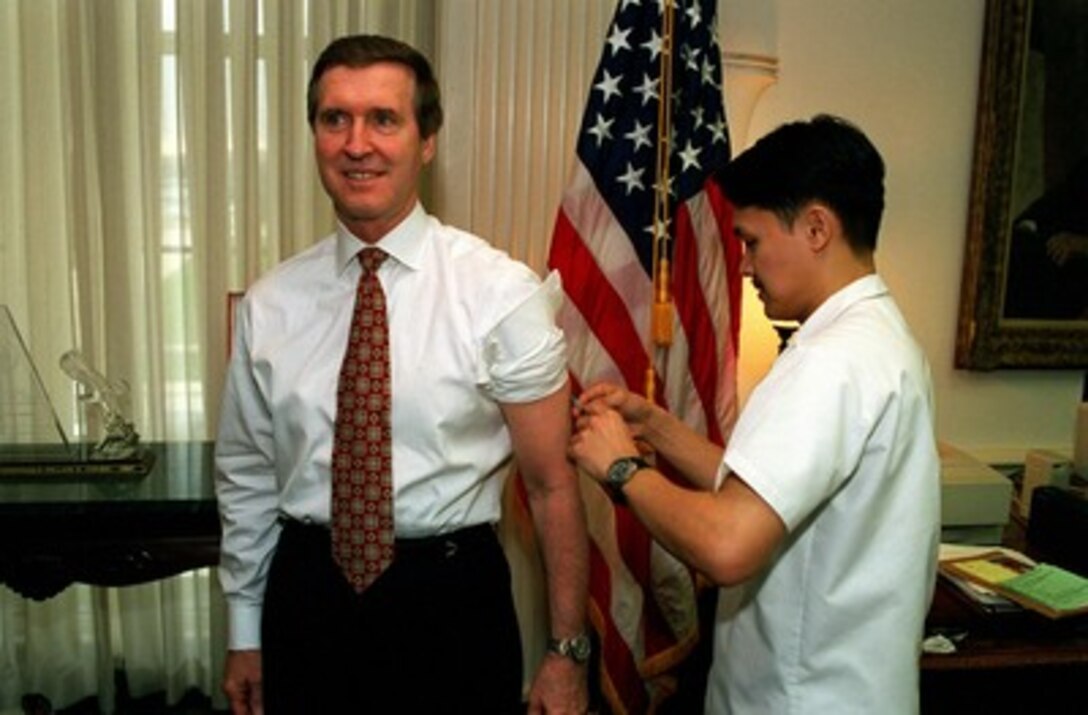 Secretary of Defense William S. Cohen receives the third in a series of six inoculations against anthrax on April 1, 1998, in the Pentagon. 