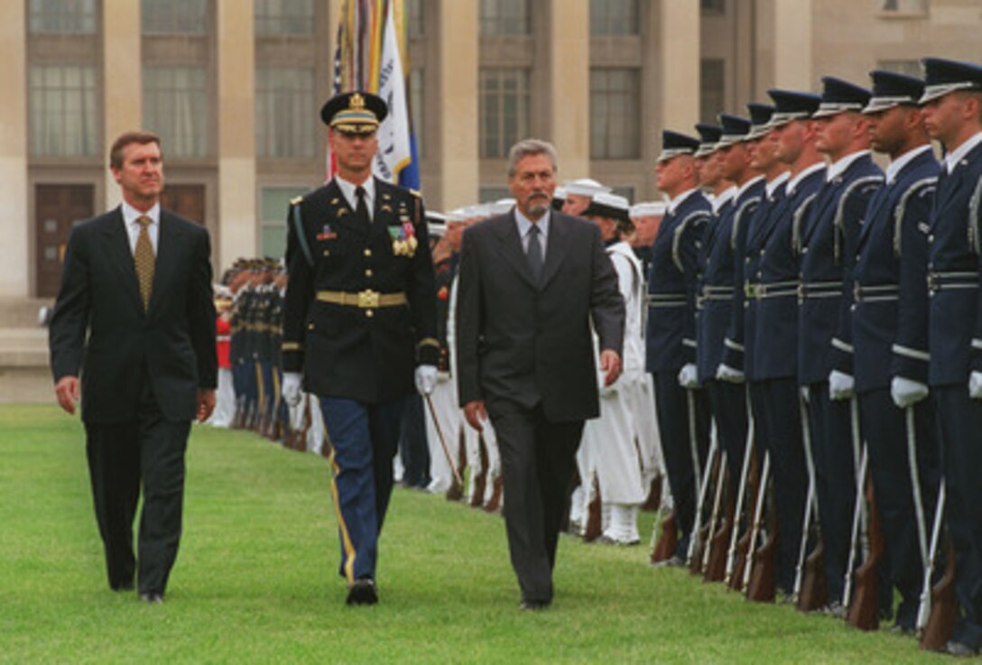 Secretary of Defense William S. Cohen (left) joins his guest, visiting Romanian President Emil Constantinescu (right), as he inspects the joint services honor guard at the Pentagon, July 17, 1998. Accompanying the dignitaries is the Commander of Troops for the ceremony Lt. Col. Mark Armstrong. The full honor arrival ceremony was just the start to a busy morning which included meetings with Cohen and other senior Department of Defense officials and a press conference. Romania is an active participant in NATO's Partnership for Peace programs and is directing its efforts towards achieving full NATO membership at some point in the future. 