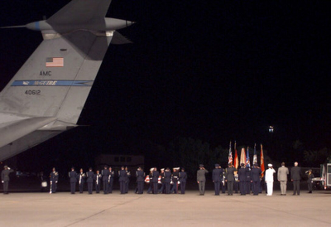 U.S. Marines carry the flag-draped coffin of an American killed in the U.S. Embassy bombing in Nairobi, Kenya, from a U.S. Air Force C-141 Starlifter to a hearse at Ramstein Air Base, Germany, on Aug. 11, 1998. Secretary of State Madeleine Albright will escort the remains of the 11 Americans killed in the bombing to Andrews Air Force Base, Md., on Thursday. 