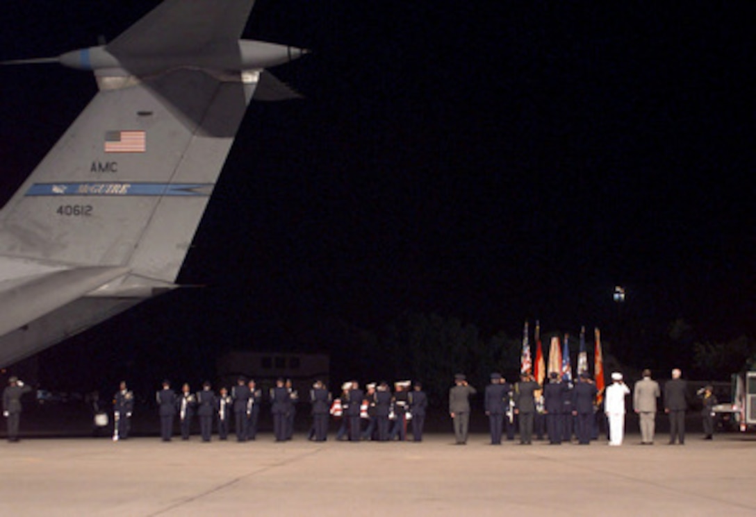 U.S. Marines carry the flag-draped coffin of an American killed in the U.S. Embassy bombing in Nairobi, Kenya, from a U.S. Air Force C-141 Starlifter to a hearse at Ramstein Air Base, Germany, on Aug. 11, 1998. Secretary of State Madeleine Albright will escort the remains of the 11 Americans killed in the bombing to Andrews Air Force Base, Md., on Thursday. 