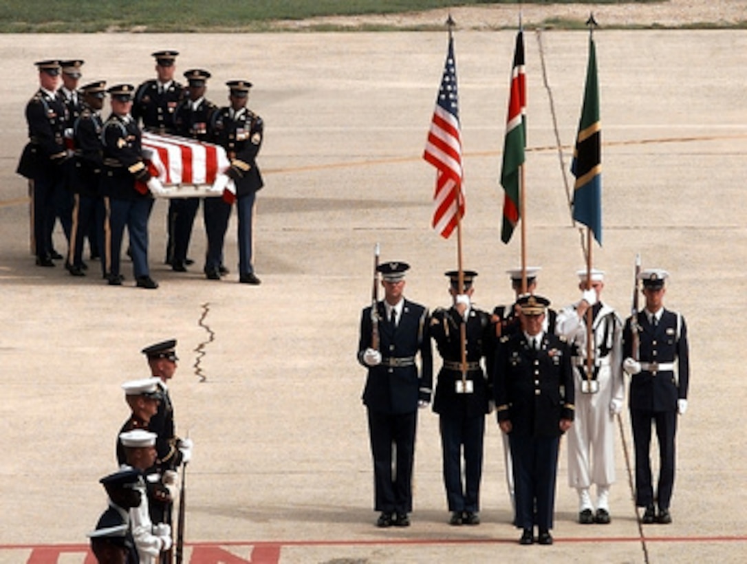 Soldiers of the Army's 3rd Infantry (The Old Guard) carry the remains of a victim of the bombing of the U.S. Embassy in Nairobi, Kenya, to a ceremony at Andrews Air Force Base, Md., on Aug. 13, 1998. Ten victims of the bombing were accompanied on their flight to Andrews from Ramstein Air Base, Germany, by Secretary of State Madeleine Albright. 