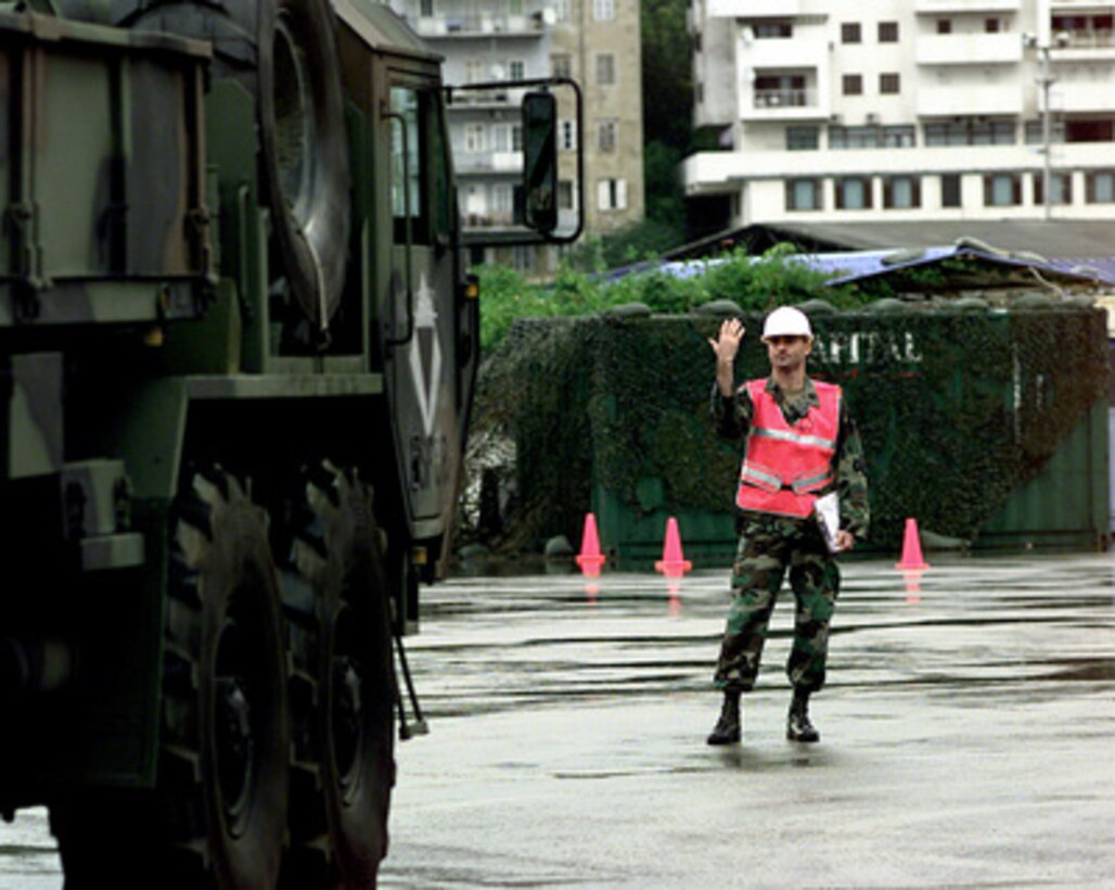 Port Operations Officer 1st Lt. Stephen Boisvert, U.S. Army, directs a vehicle into the cargo yard as it rolls off the Military Sealift Command ship USNS Soderman at Rijeka, Croatia, on Aug. 23, 1998. Soderman, one of the U.S. Navy's large, medium-speed, roll-on/roll-off ships, is off-loading 29 helicopters and hundreds of vehicles and containers in support of the U.S. Army 1st Cavalry Division deployment to Bosnia and Herzegovina for Operation Joint Forge. This is the first time a port in the former Republic of Yugoslavia is being used to off-load heavy combat equipment in support of NATO peacekeeping forces in the region. The 1st Cavalry is deployed from Fort Hood, Texas. Boisvert is attached to the 839th Transportation Battalion. 