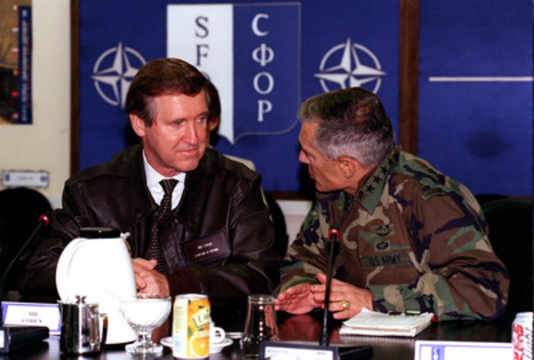 Secretary of Defense William Cohen listens to Gen. Wesley Clark, U.S. Army, supreme allied commander Europe, during a meeting at the headquarters of the NATO Stabilization Force in Sarajevo, Bosnia and Herzegovina, on Sept. 27, 1998. 