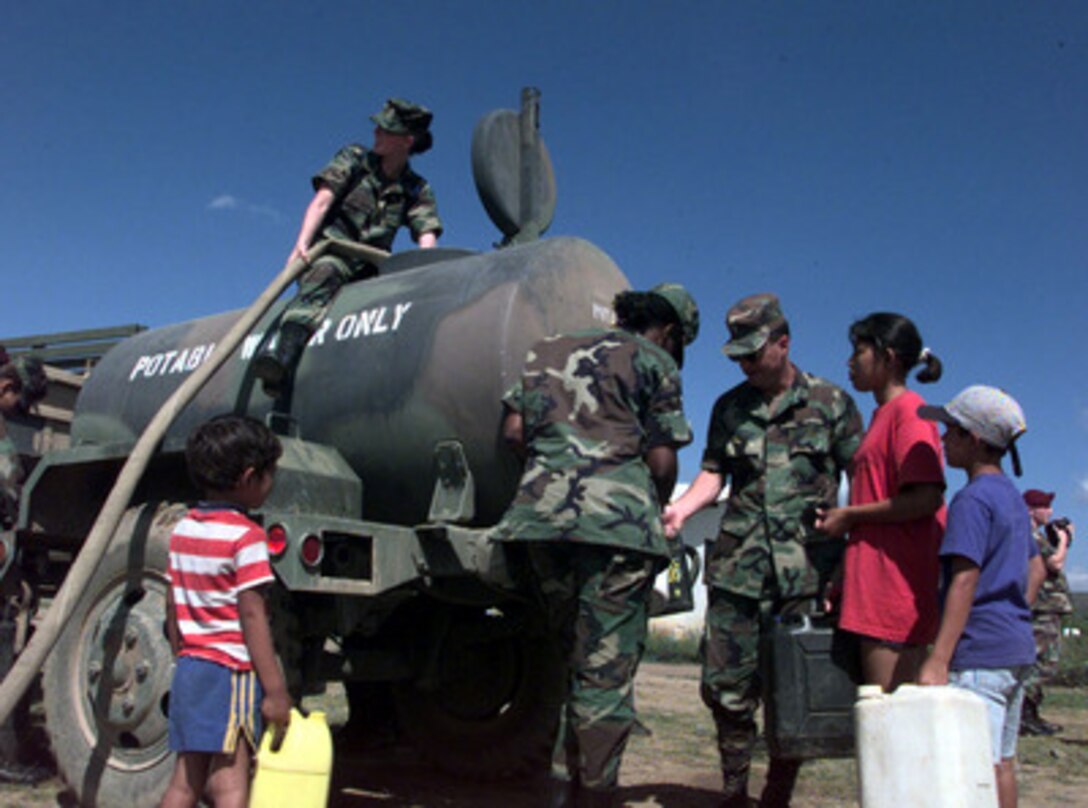 U.S. Army Headquarters and Support Company personnel from Soto Cano Air Base, Honduras, deliver a water buffalo of clean drinking water to the town of Comayagua, Honduras, on Nov. 10, 1998. Over 1,000 U.S. service members are helping to rush food, shelter, pure water, medical aid and other relief supplies to the central Americans made homeless by Hurricane Mitch. 