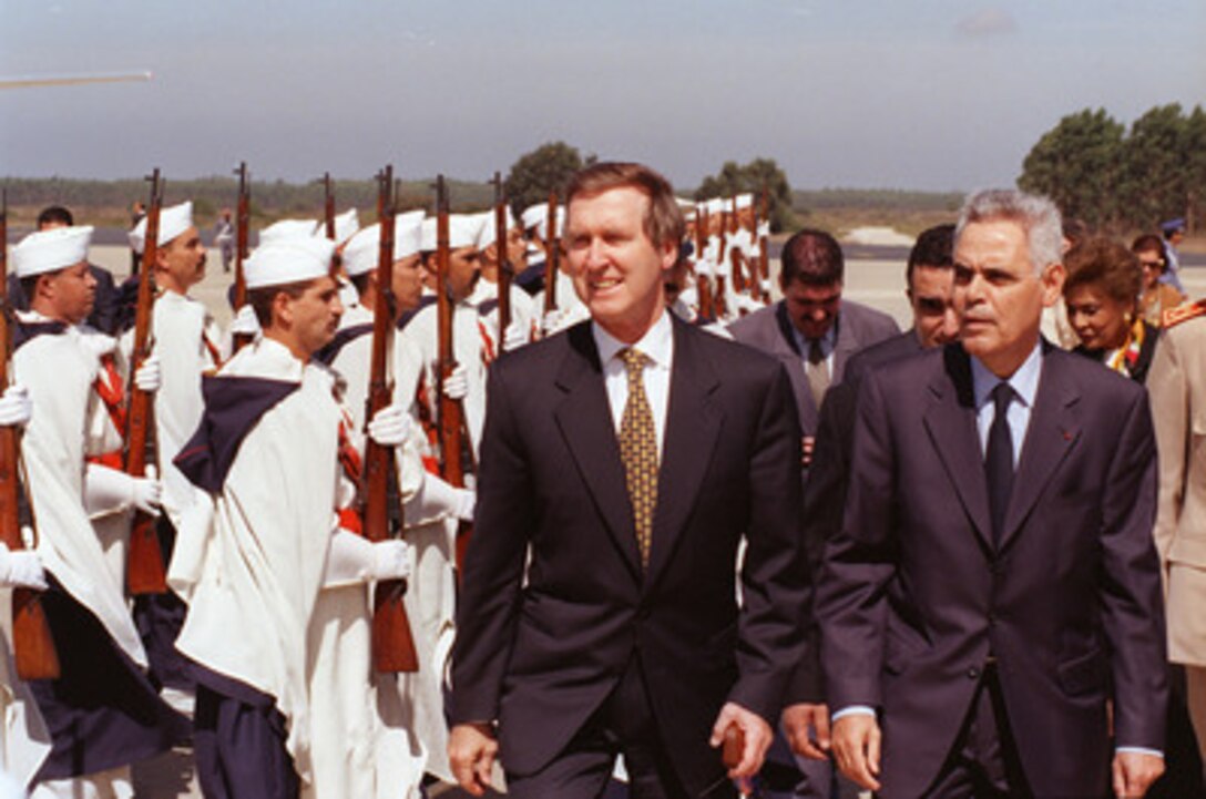 Secretary of Defense William Cohen (left) inspects the Moroccan honor guard upon his arrival at the airport in Rabat, Morocco, on Sept. 28, 1998. Cohen is being escorted by Abderrahmane Sbai (right), the minister delegate to the prime minister for administration of national defense. 