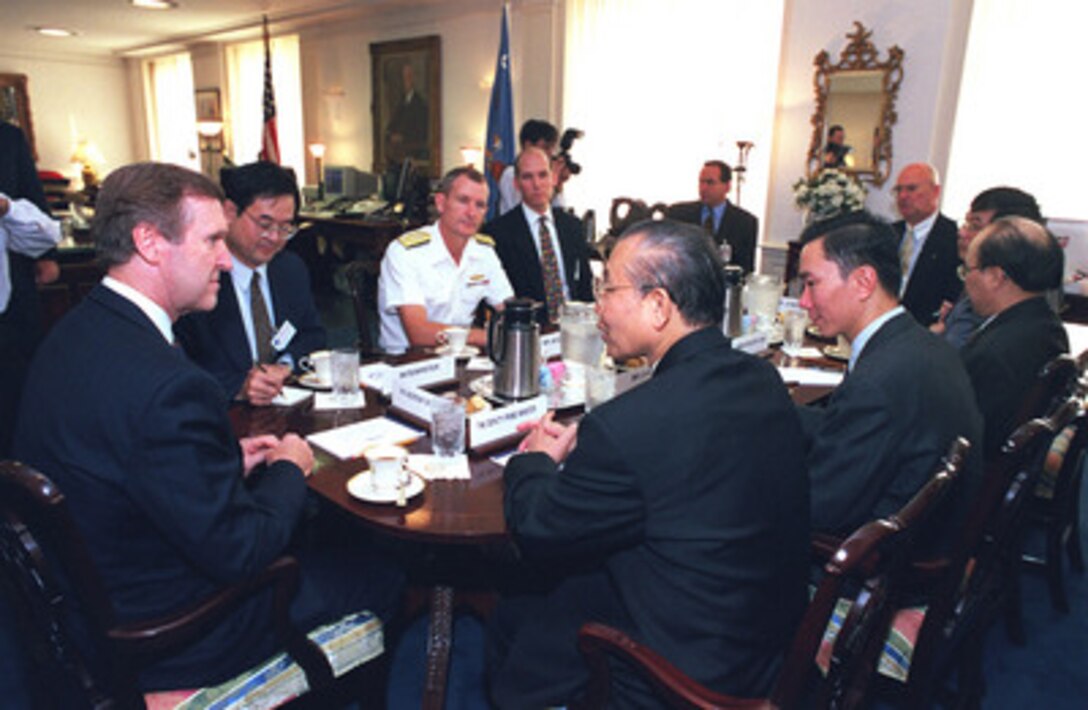 Secretary of Defense William Cohen (left) meets with a delegation from the Socialist Republic of Vietnam led by Deputy Prime Minister/Foreign Minister Nguyen Manh Cam (right foreground) in Cohen's Pentagon office on Oct. 1, 1998. 