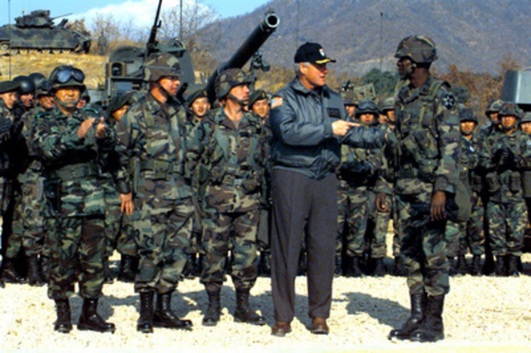 President Bill Clinton surprises Command Sgt. Maj. Charles L. Thomas by recognizing Thomas' birthday on Nov. 22, 1998, during his four-day visit to the Republic of Korea. Clinton spent time with U.S. Army and Republic of Korea soldiers and got a first hand look at a variety of armored vehicles belonging to the U. S. Army's 2nd Infantry Division and the 5th Republic of Korea Armored Brigade while they conducted combined training at the Korean Training Center. Thomas is the Command Sgt. Maj. of the 2d Battalion, 9th Infantry Regiment, 2nd Infantry Division, U.S. Army. 