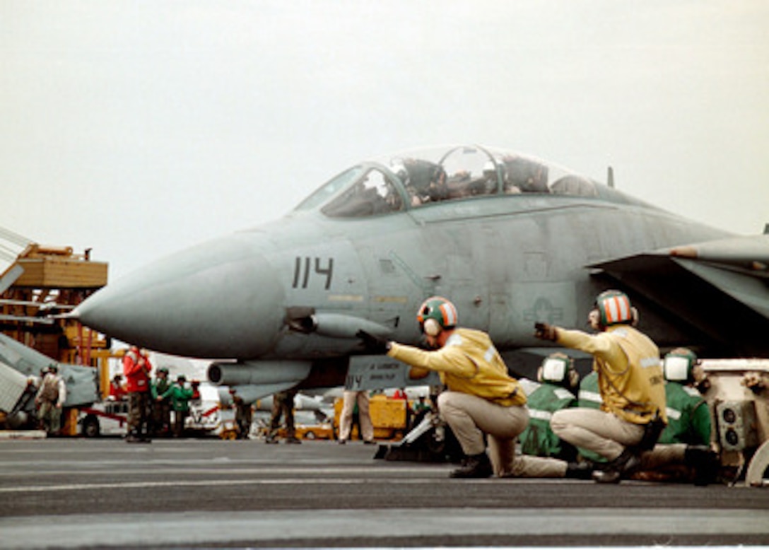 A U.S. Navy F-14B Tomcat is given the signal to launch from the flight deck of the USS Enterprise (CVN 65) as the aircraft carrier operates in the Persian Gulf on Dec. 1, 1998. Enterprise and its embarked Carrier Air Wing 3 are on station in the Persian Gulf in support of Operation Southern Watch, which is the U.S. and coalition enforcement of the no-fly-zone over Southern Iraq. The Tomcat belongs to Fighter Squadron 32, Naval Air Station Oceana, Va. 