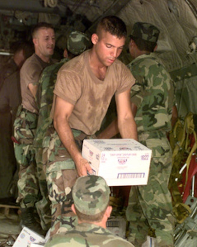 Spc. Juan Nieves, U.S. Army, helps off load a 9,500 pound cargo of food and medical supplies from a U.S. Air Force C-27 Spartan at a dirt airstrip in Mocoron, Honduras, on Nov. 20, 1998. Over 1,800 U.S. service members are helping to rush food, shelter, pure water and medical aid to the central Americans made homeless by Hurricane Mitch. Nieves is attached to the Headquarters Support Company, Soto Cano Air Base, Honduras. The Spartan is attached to the 310th Airlift Squadron, Howard Air Force Base, Panama. 