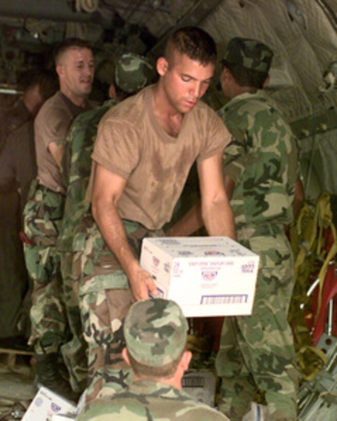 Spc. Juan Nieves, U.S. Army, helps off load a 9,500 pound cargo of food and medical supplies from a U.S. Air Force C-27 Spartan at a dirt airstrip in Mocoron, Honduras, on Nov. 20, 1998. Over 1,800 U.S. service members are helping to rush food, shelter, pure water and medical aid to the central Americans made homeless by Hurricane Mitch. Nieves is attached to the Headquarters Support Company, Soto Cano Air Base, Honduras. The Spartan is attached to the 310th Airlift Squadron, Howard Air Force Base, Panama. 