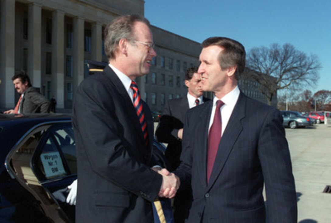 Secretary of Defense William Cohen (right) greets visiting German Minister of Defense Rudolf Scharping outside the Pentagon, Nov. 24, 1998. Following a welcoming ceremony, Cohen and Scharping will meet to discuss a range of security issues of interest to both nations. 