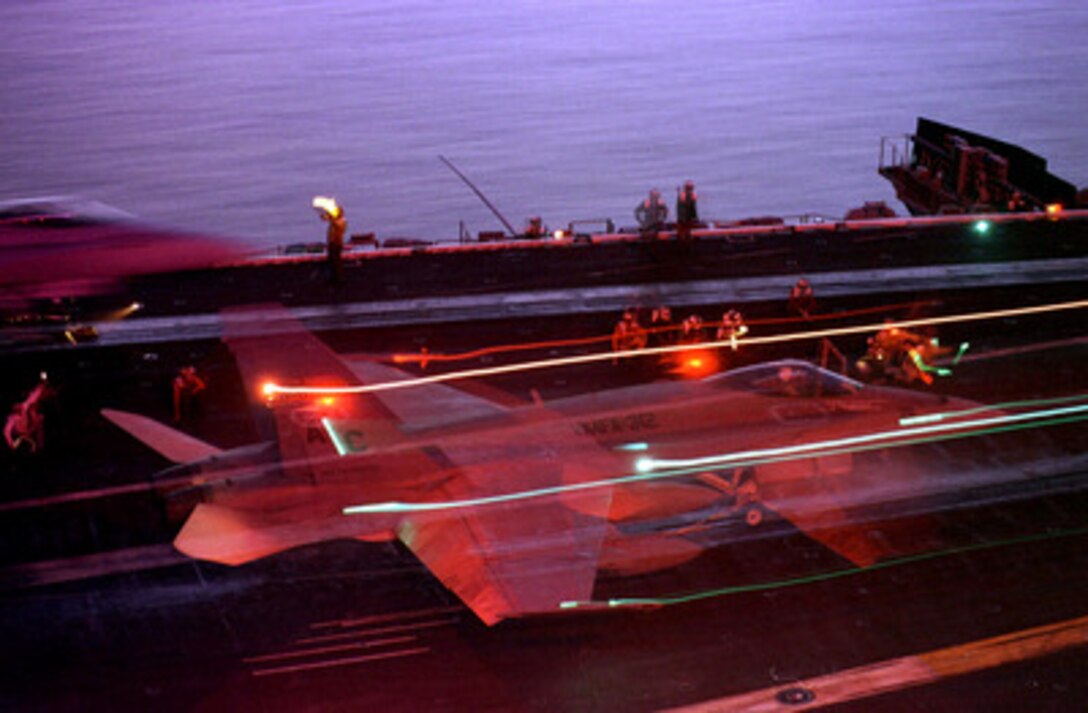 A U. S. Marine Corps F/A-18 Hornet leaves trails of light in this time exposure as it launches at night from the flight deck of the USS Enterprise (CVN 65) on Nov. 25, 1998. Enterprise and its embarked Carrier Air Wing 3 are on station in the Persian Gulf in support of Operation Southern Watch, which is the U.S. and coalition enforcement of the no-fly-zone over Southern Iraq. The Hornet belongs to Fighter Attack Squadron 312, Marine Corps Air Station, Beaufort, S.C. 