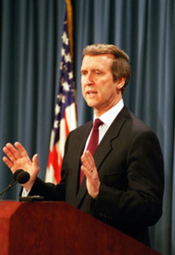 Secretary of Defense William S. Cohen briefs members of the press in the Pentagon on the attack of selected targets in Iraq on Dec. 16, 1998, as part of Operation Desert Fox. 