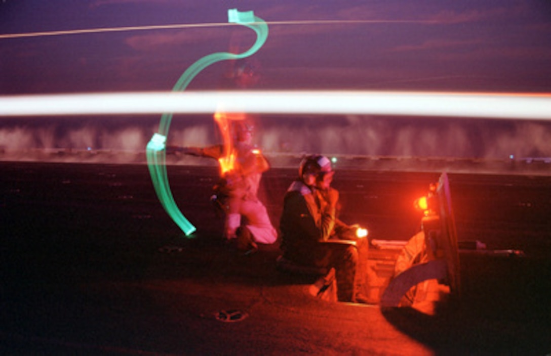 Night time flight operations on the flight deck of the USS Enterprise (CVN 65) become a ballet of light as the aircraft carrier launches strikes against Iraq on Dec. 17, 1998, Iraq in support of Operation Desert Fox. Enterprise and its embarked Carrier Air Wing 3 are operating in the Persian Gulf in support of Operation Desert Fox. 