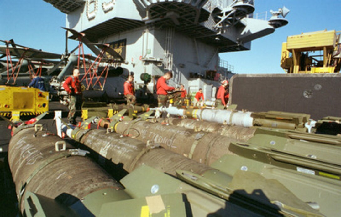 Aviation ordnancemen ready bombs for loading onto various aircraft on the flight deck of the USS Enterprise (CVN 65) for a third wave of air strikes against Iraq on Dec. 18, 1998, during Operation Desert Fox. Enterprise and its embarked Carrier Air Wing 3 are operating in the Persian Gulf in support of Desert Fox. 