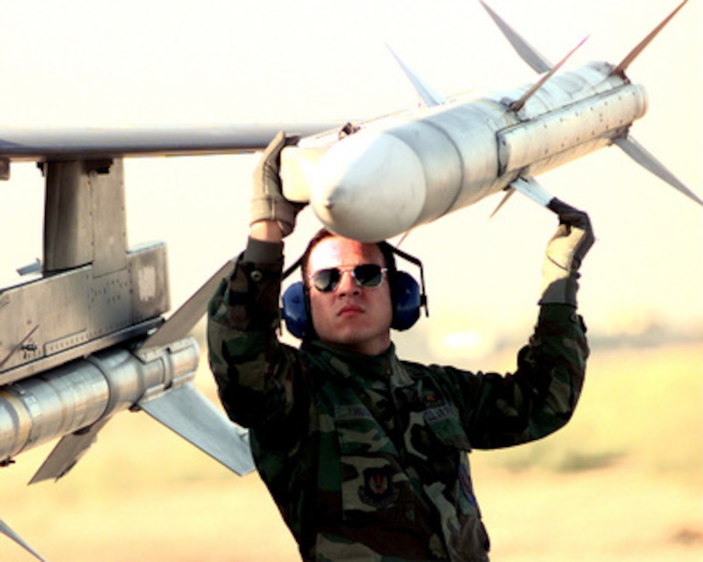 Armament Technician Senior Airman Hector Huguet checks an AIM-120 Advanced Medium Range Air-to-Air Missile, or AMRAAM, on an F-16CJ Fighting Falcon before it takes off from Incirlik Air Base, Turkey, on Dec. 28, 1998, for a mission supporting Operation Northern Watch. Northern Watch is the coalition enforcement of the no-fly-zone over Northern Iraq. Huguet is attached to the 23rd Expeditionary Fighter Squadron. 