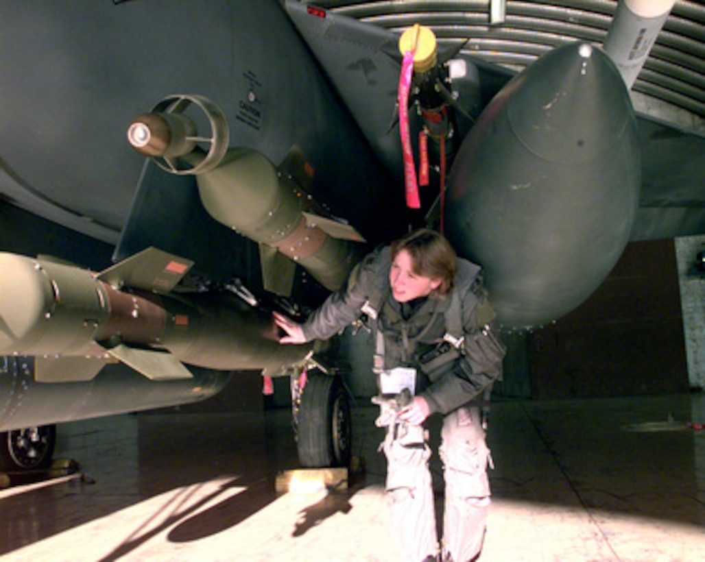 U.S. Air Force Pilot Capt. Kerry Kane performs preflight checks on precision guided munitions loaded on an F-15E Strike Eagle at Incirlik Air Base, Turkey, on Dec. 30, 1998. Strike Eagles fly radar suppression and radar-jamming missions for Operation Northern Watch, which is the coalition enforcement of the no-fly-zone over Northern Iraq. Kane is attached to the 494th Fighter Squadron at RAF Lakenheath, United Kingdom. 