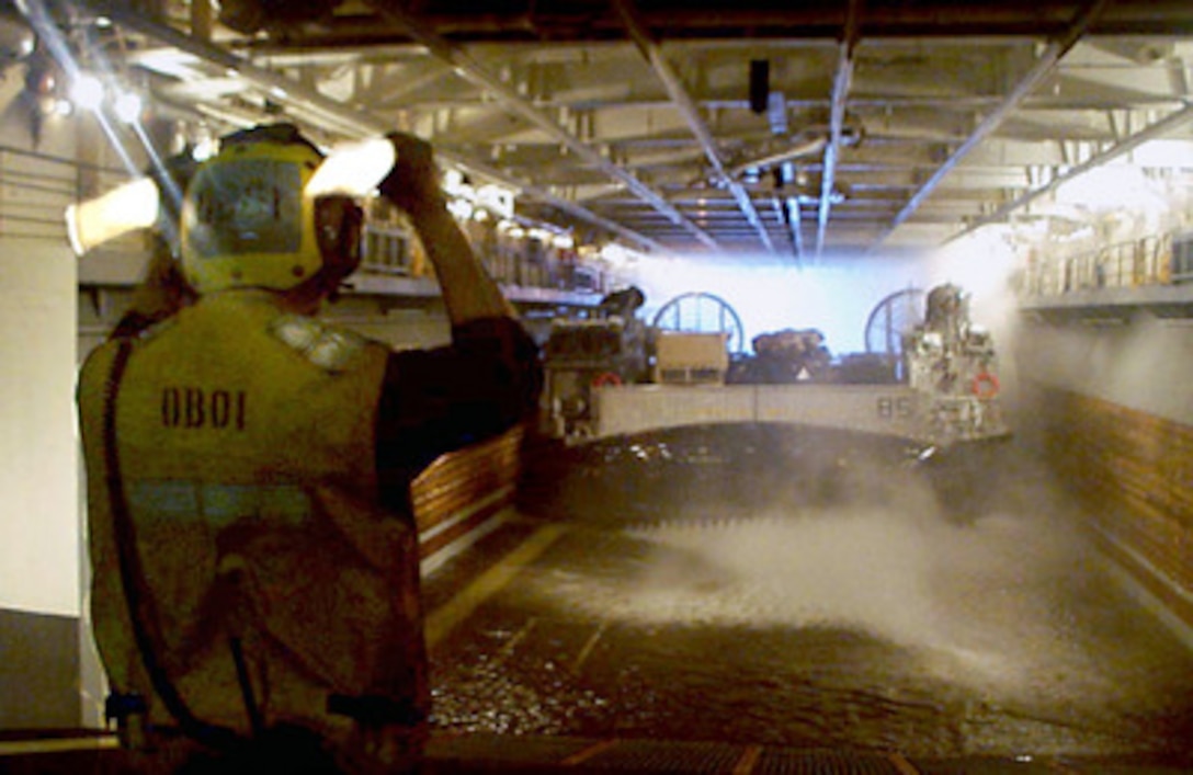 Petty Officer 3rd Class Kyle Smith guides a Landing Craft Air Cushion, more commonly known as an LCAC, into the well deck of the amphibious assault ship USS Wasp (LHD 1) on Jan. 13, 1998, during Joint Task Force Exercise 98-1. More than 30,000 U.S. military personnel are participating in the exercise which is testing joint forces on their ability to deploy rapidly and conduct joint operations during a crisis. All branches of the armed forces are training side-by-side using the latest advances in technology in a simulated high-threat environment that involves air, naval and ground operations. The LCAC is attached to Assault Craft Unit 4. 