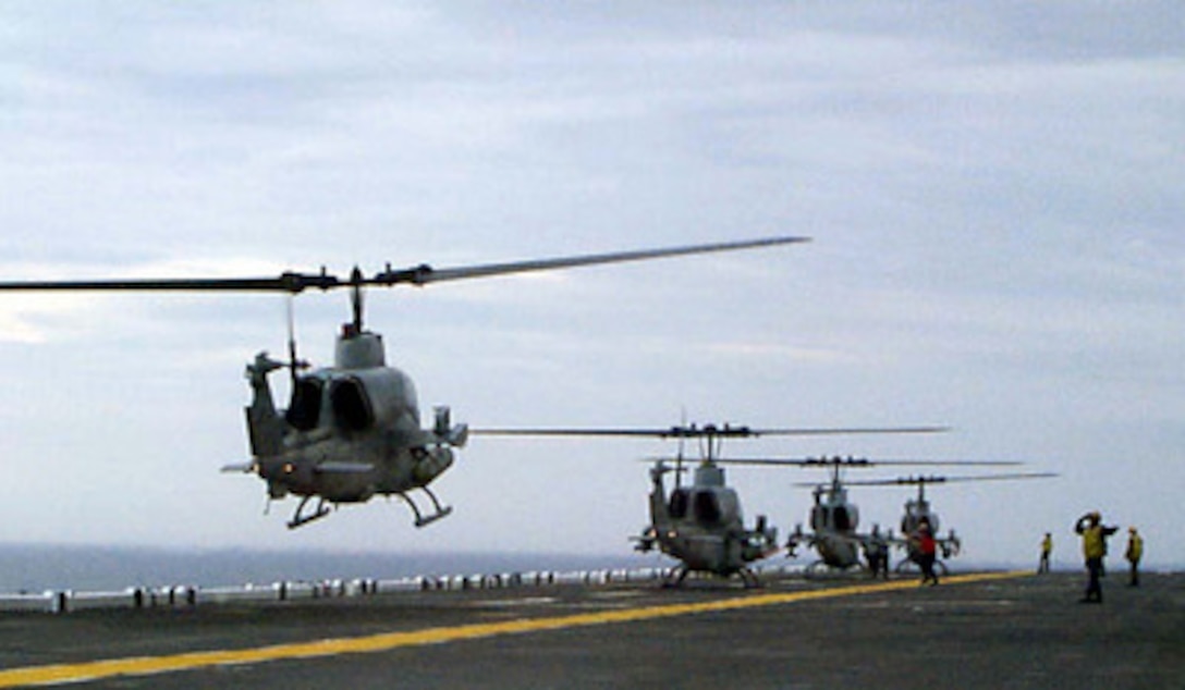 U.S. Marine Corps AH-1W Super Cobra helicopters land aboard the amphibious assault ship USS Wasp (LHD 1) on Jan. 13, 1998, during Joint Task Force Exercise 98-1. More than 30,000 U.S. military personnel are participating in the exercise which is testing joint forces on their ability to deploy rapidly and conduct joint operations during a crisis. All branches of the armed forces are training side-by-side using the latest advances in technology in a simulated high-threat environment that involves air, naval and ground operations. The Super Cobras are attached to Helicopter Medium Squadron 264 , Marine Corps Air Station New River, N.C. 