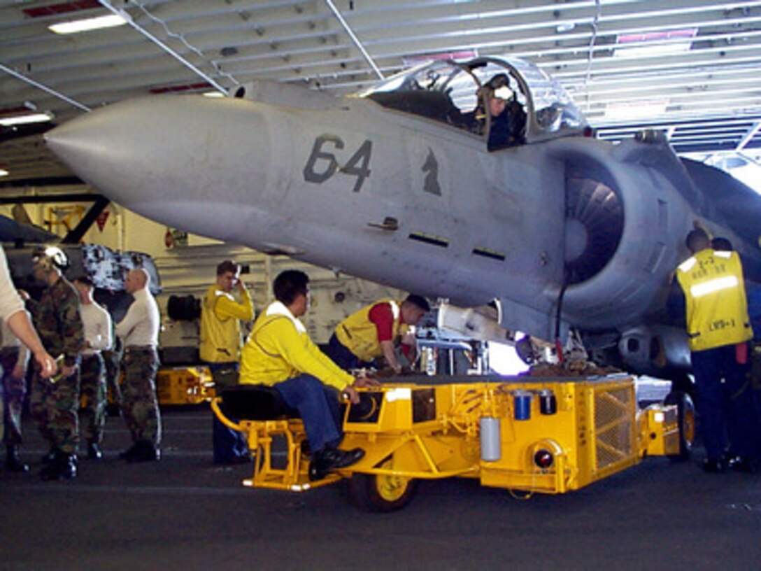 Crew members aboard the amphibious assault ship USS Wasp (LHD 1) move a U.S. Marine Corps AV-8B Harrier to the flight deck elevator on Jan. 16, 1998, in preparation for flight operations during Joint Task Force Exercise 98-1. More than 30,000 U.S. military personnel are participating in the exercise which is testing joint forces on their ability to deploy rapidly and conduct joint operations during a crisis. All branches of the armed forces are training side-by-side using the latest advances in technology in a simulated high-threat environment that involves air, naval and ground operations. 